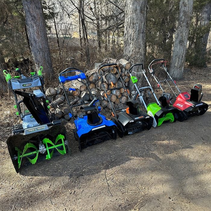 All snow blowers lined up in forest